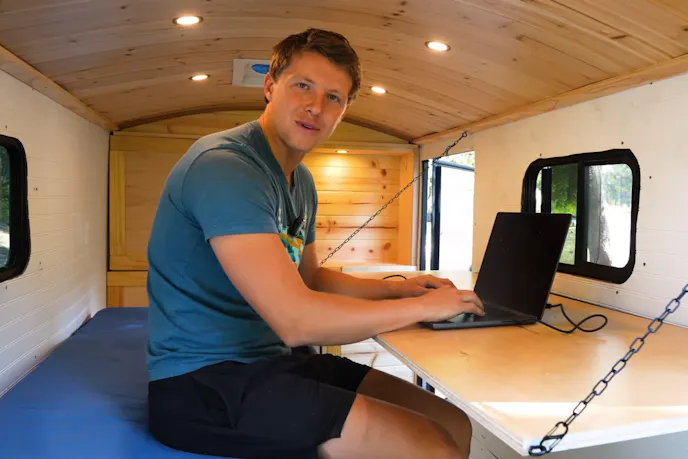 Desk and a bed inside a trailer